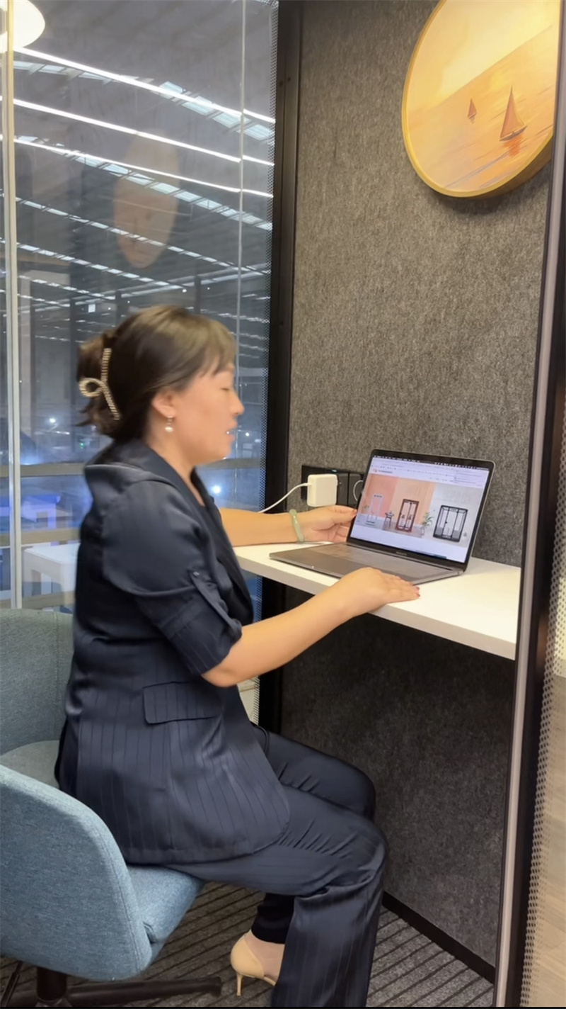 person sitting in office booth blue